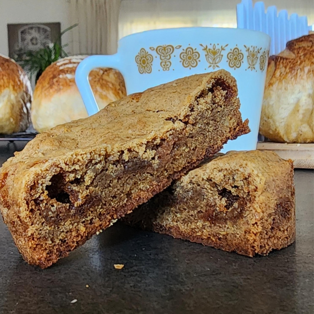 cookie on counter with coffee mug behind it